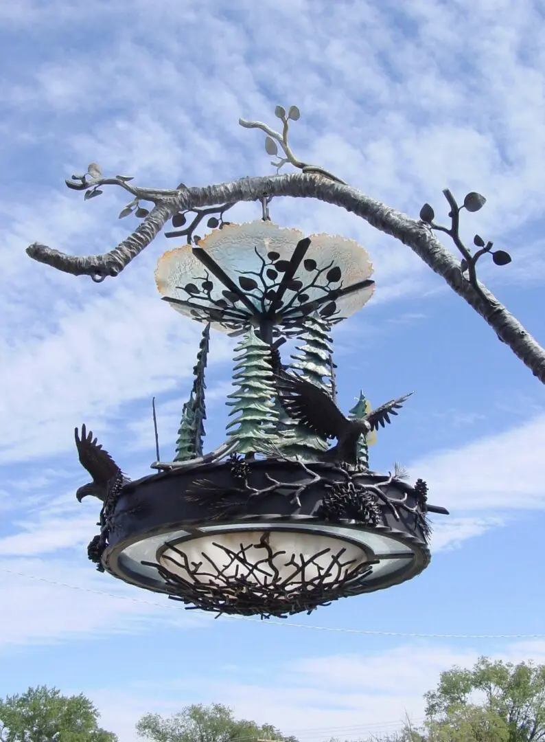 A bird feeder hanging from the ceiling of a tree.