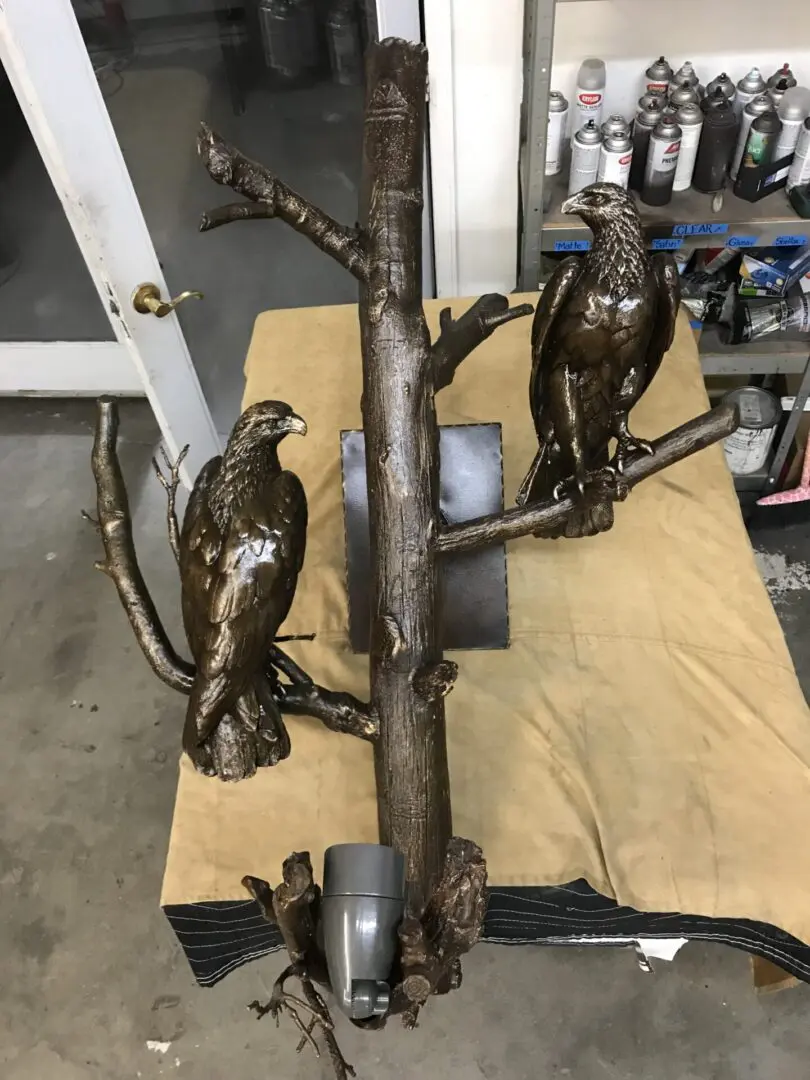 Two birds sitting on a tree branch in the middle of a workshop.