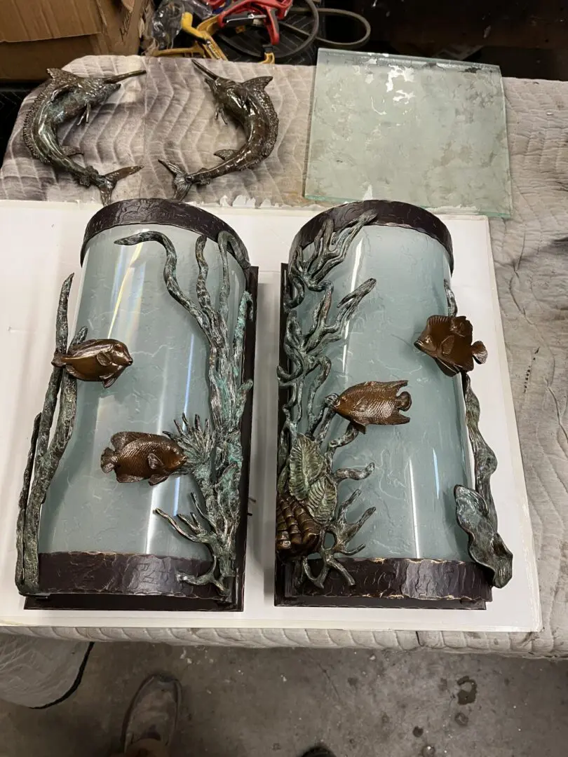 A pair of wall sconces with sea life on them.