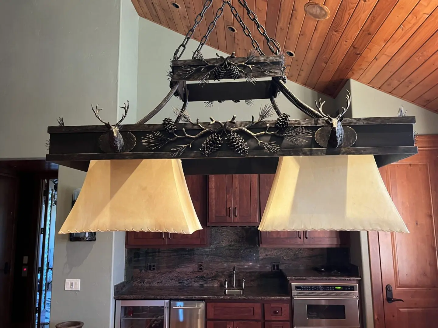 A chandelier hanging from the ceiling in a kitchen.