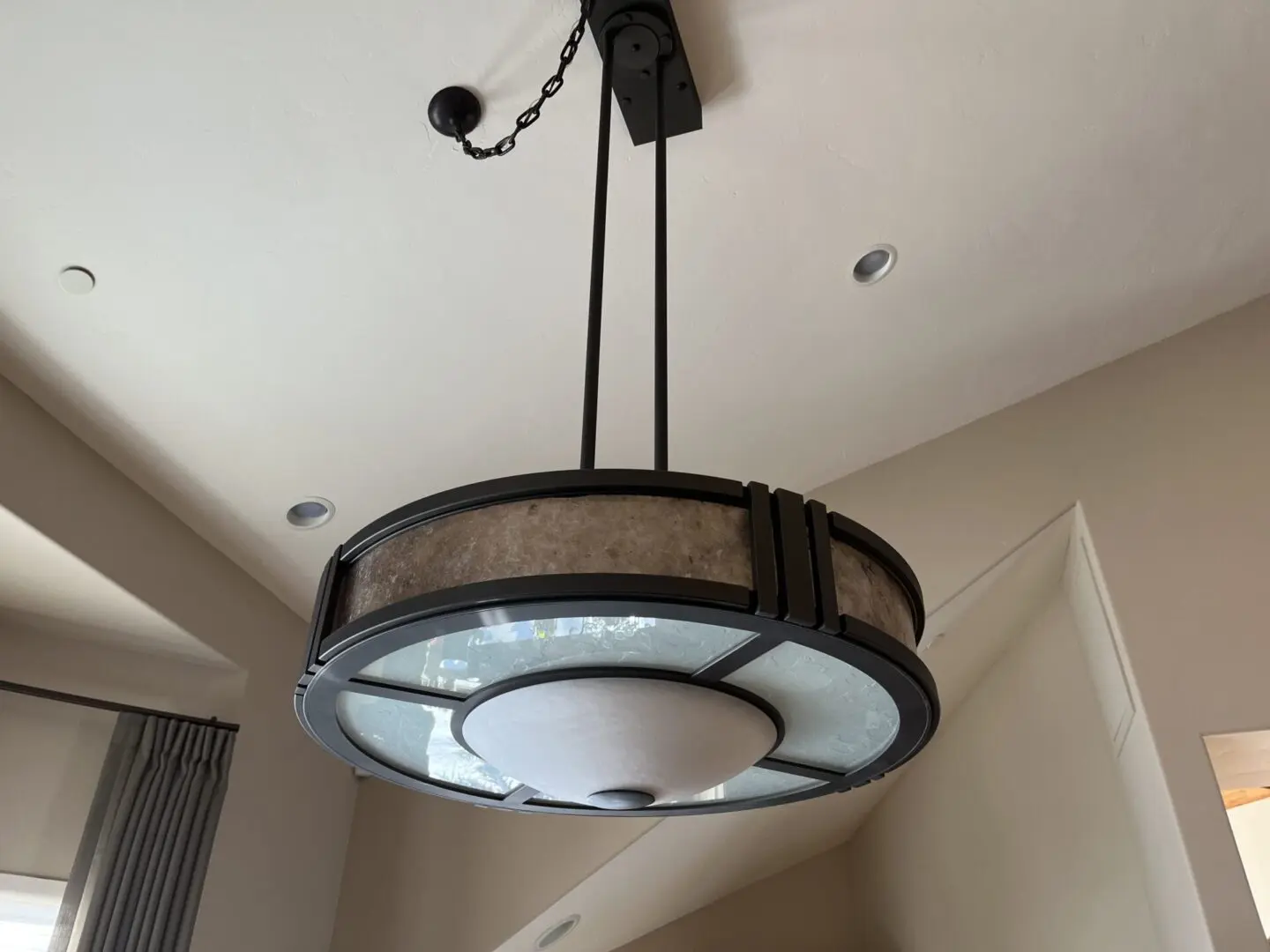 A light fixture hanging from the ceiling in a room.