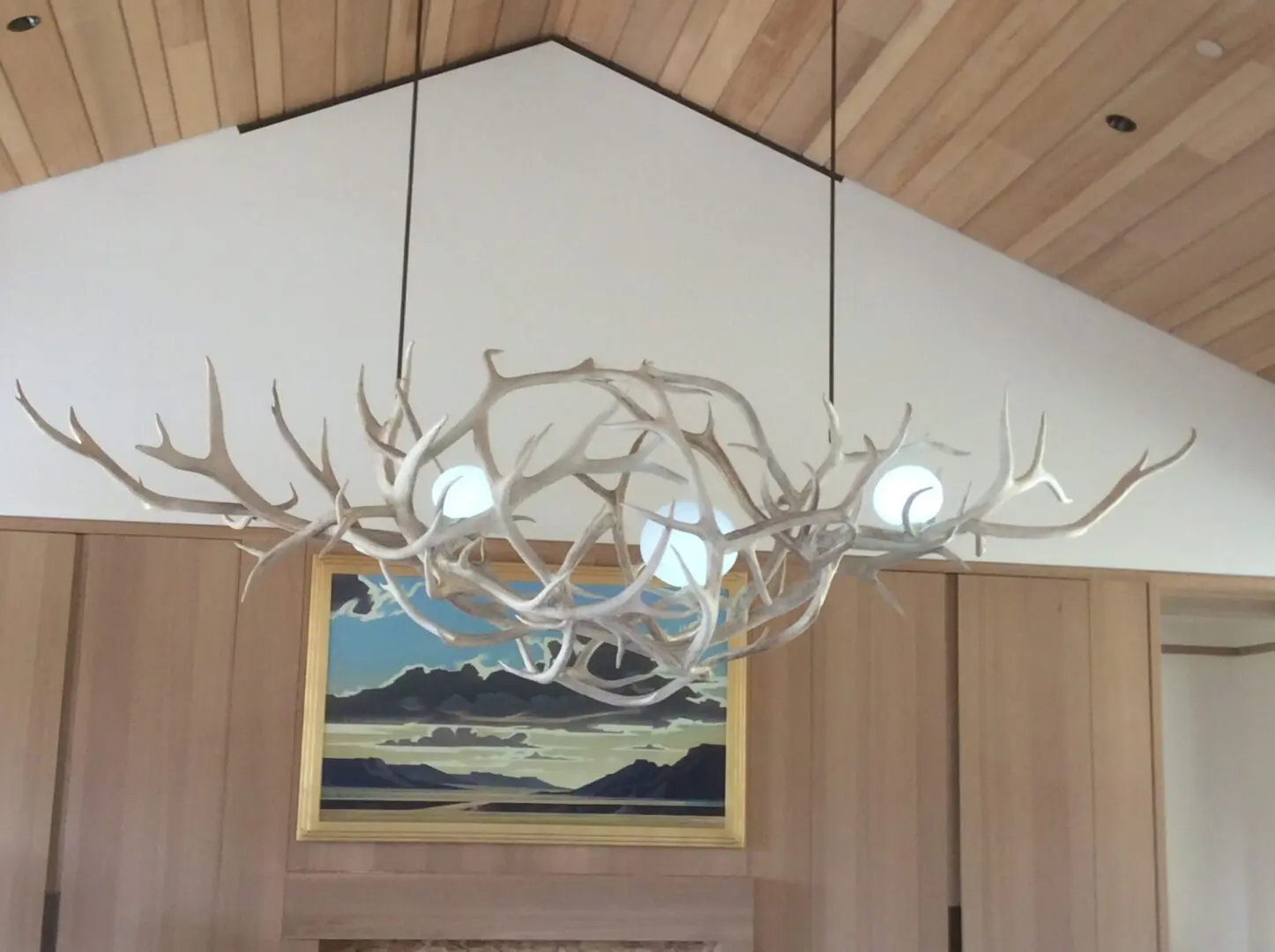 A large antler chandelier hanging from the ceiling.