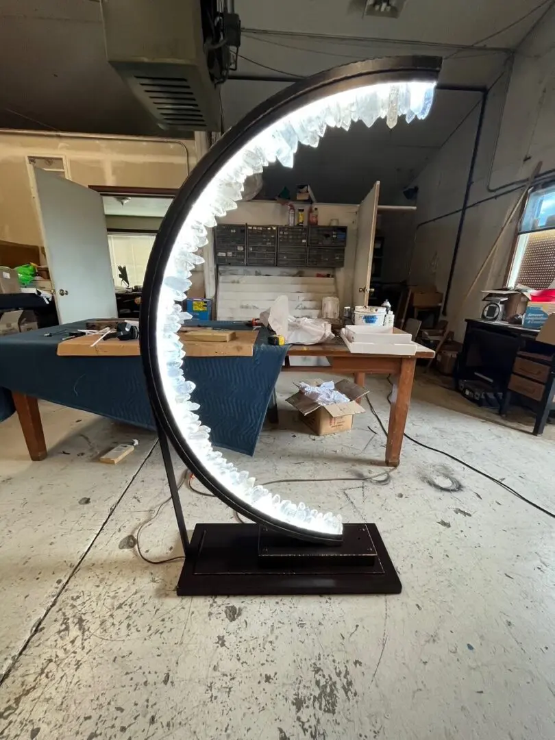 A large circular lamp in the shape of a crescent moon.